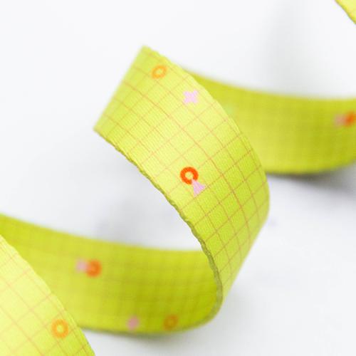 Power Gridra Neon Yellow 1-inch polyester webbing by Rashida Coleman-Hale featuring a subtle grid design with small colorful accents on a bright neon yellow background.