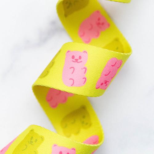 Gummy Bears Citron 1.5-inch polyester webbing by Kimberly Kight featuring pink and olive green gummy bear motifs on a bright citron yellow background.