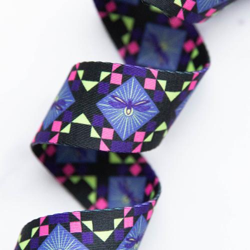 Dragonfly Pixels 1.5-inch polyester webbing by Sarah Watts featuring purple and blue dragonfly motifs with pink and lime green geometric accents on black.