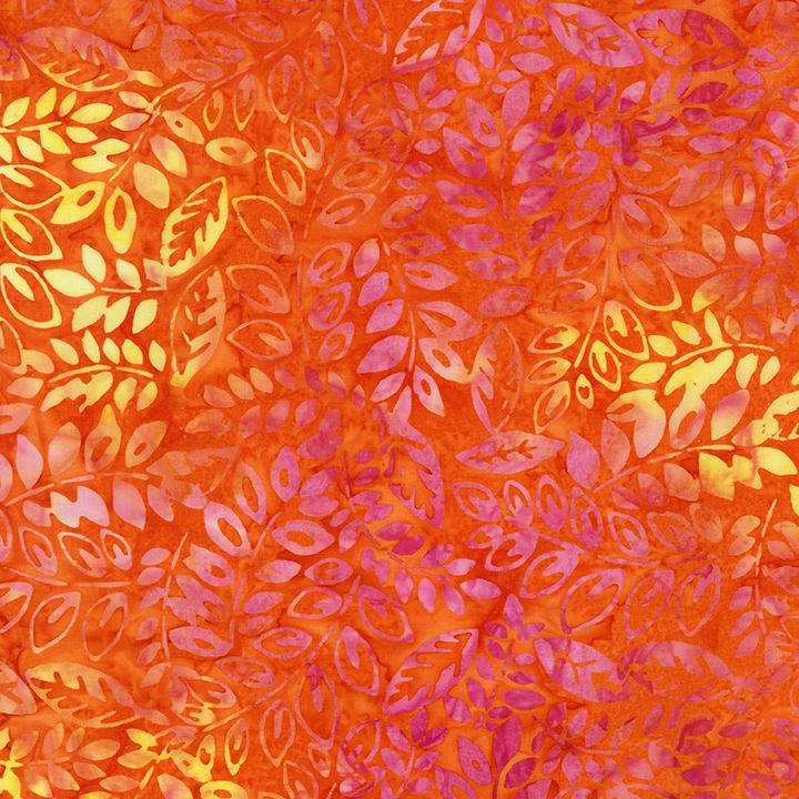 Orange and pink batik fabric featuring cascading vine leaves and botanical motifs from the Tonga Batik collection by Timeless Treasures.