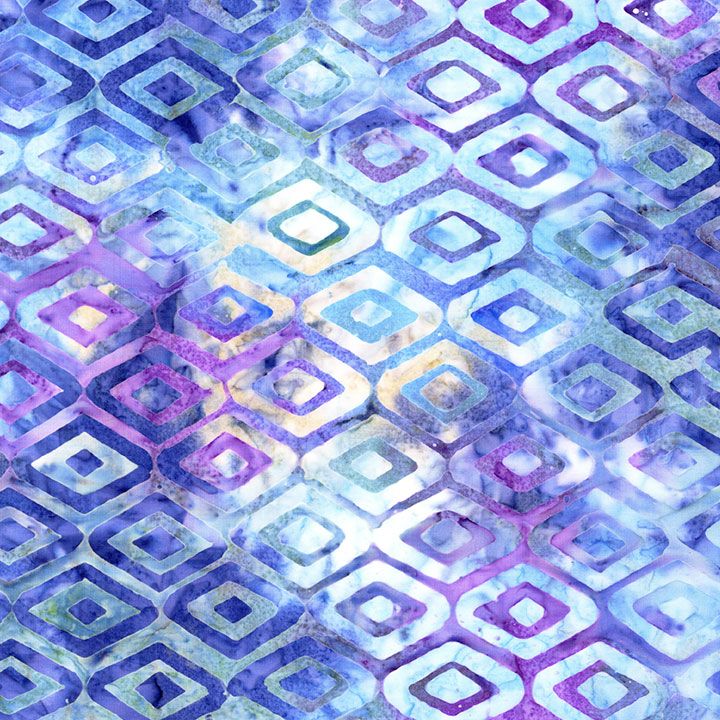 Blue, aqua, and lavender batik fabric featuring geometric diamond patterns from the Tonga Royal Diamond collection by Timeless Treasures.