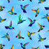 Flying Hummingbirds Blue fabric by Chong-A Hwang for Timeless Treasures featuring colorful hummingbirds in flight on a soft sky-blue background with vibrant jewel-tone details.