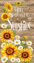 You Are My Sunshine cotton panel fabric featuring large sunflowers, white daisies, bees, rustic wood background, and inspirational typography by Timeless Treasures.