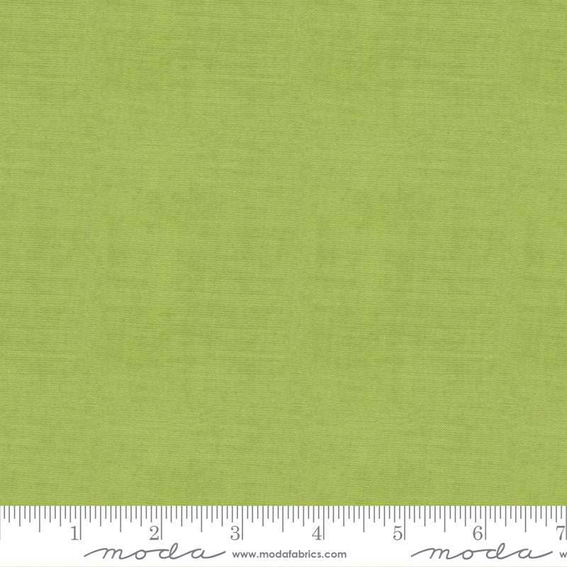 Crossweave Limeade woven cotton fabric featuring a fresh lime green linen-look texture by Moda Fabrics.