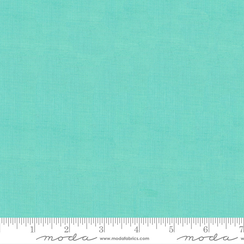 Crossweave Seaglass woven cotton fabric featuring a soft aqua blue linen-look texture by Moda Fabrics.