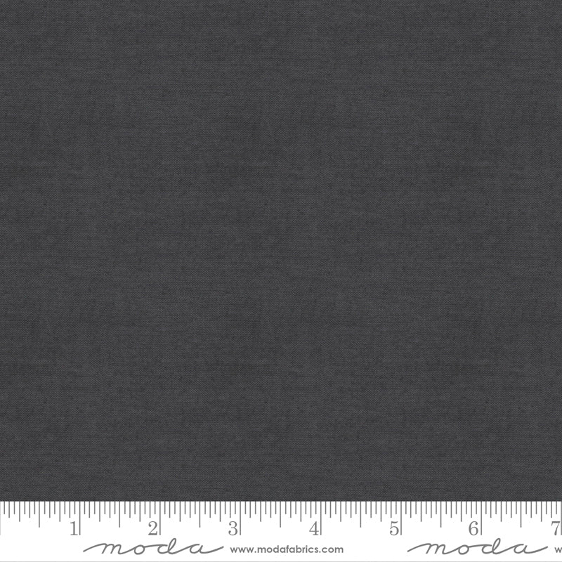 Crossweave Charcoal woven cotton fabric featuring a deep charcoal gray linen-look texture by Moda Fabrics.