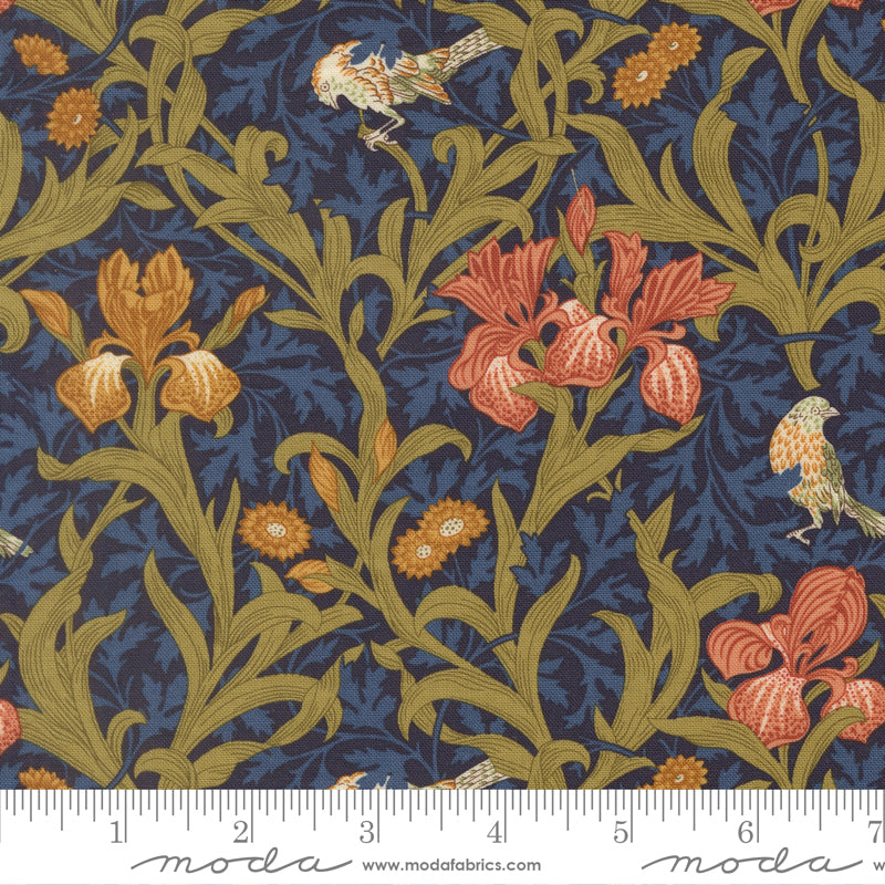 Morris Muse Iris Florals Twilight quilting cotton by Barbara Brackman for Moda Fabrics featuring coral and golden iris flowers, delicate songbirds, and scrolling olive foliage on a deep twilight blue botanical background.