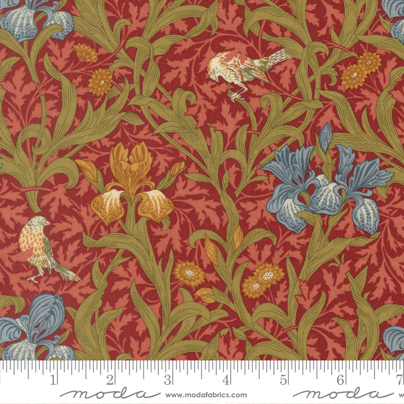 Morris Muse Iris Florals Russet quilting cotton by Barbara Brackman for Moda Fabrics featuring blue, coral, and golden iris flowers, delicate songbirds, and scrolling olive foliage on a warm russet botanical background.