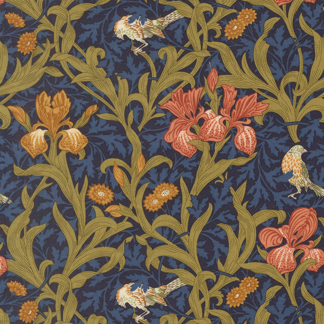 Morris Muse Iris Florals Twilight quilting cotton by Barbara Brackman for Moda Fabrics featuring coral and golden iris flowers, delicate songbirds, and scrolling olive foliage on a deep twilight blue botanical background.