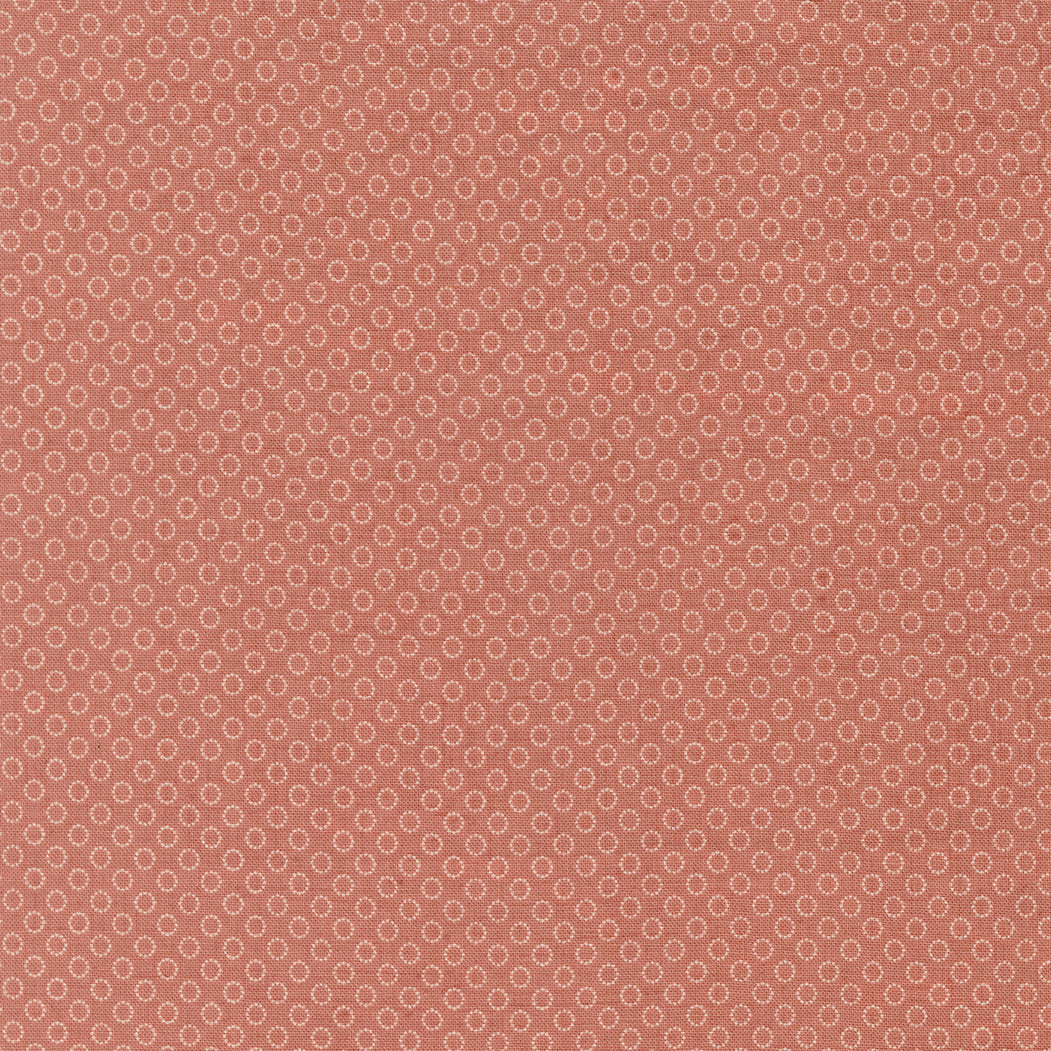 Tiny ring motif quilting cotton fabric on clay pink background by French General for Moda Fabrics