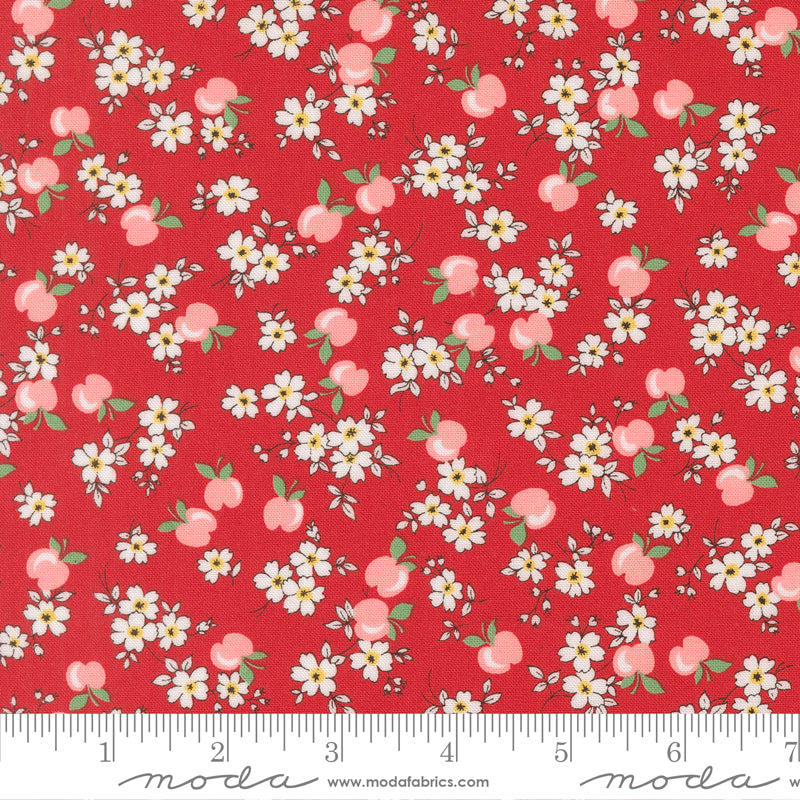 Close-up of 30s Playtime 2025 Apple Blossom Florals Scarlet fabric by Linzee McCray for Moda Fabrics, featuring white blossoms and pink apples on a deep red background.