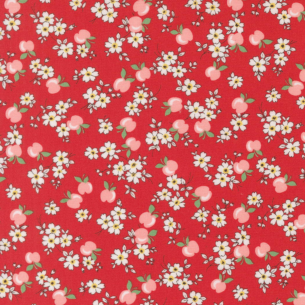Close-up of 30s Playtime 2025 Apple Blossom Florals Scarlet fabric by Linzee McCray for Moda Fabrics, featuring white blossoms and pink apples on a deep red background.