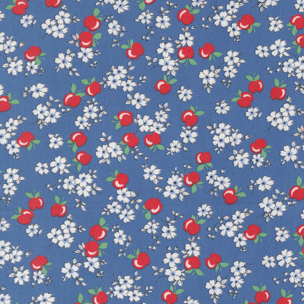 Close-up of 30s Playtime 2025 Apple Blossom Florals Bluebell Fabric by Linzee McCray for Moda Fabrics, showing red apples and white blossoms on a soft bluebell cotton background.