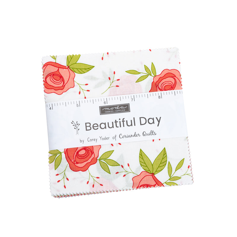 Beautiful Day Charm Pack by Corey Yoder for Moda Fabrics featuring 42 coordinated 5-inch cotton fabric squares with roses, florals, dots, stripes, and fresh spring-inspired prints in coral, pink, green, gray, and white.
