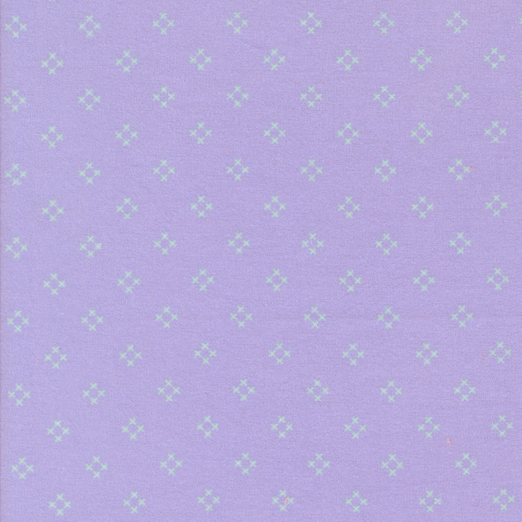 Sherbet Sunshine Flannel Diamond X Wisteria fabric by Corey Yoder of Coriander Quilts for Moda Fabrics featuring light lavender cross design on wisteria background.