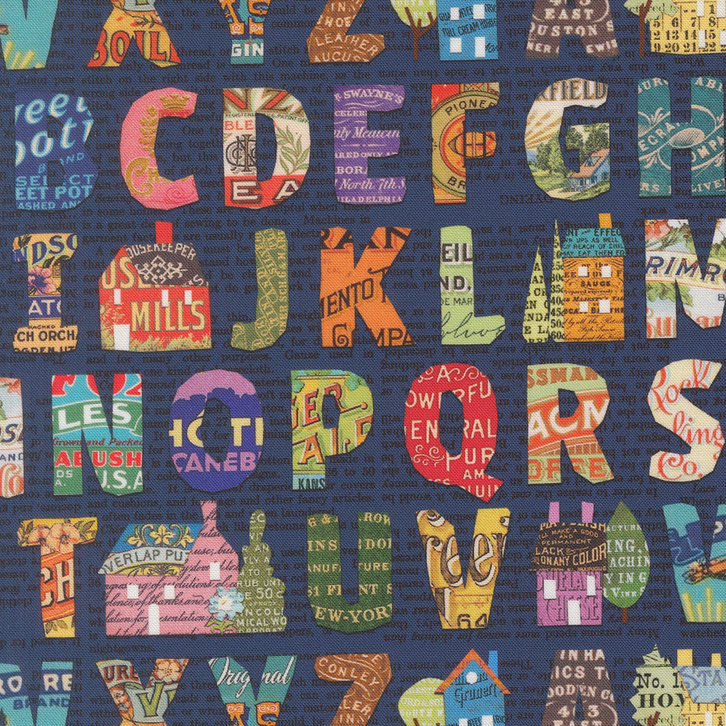 Colorful alphabet collage print on navy background by Cathe Holden for Moda Fabrics.