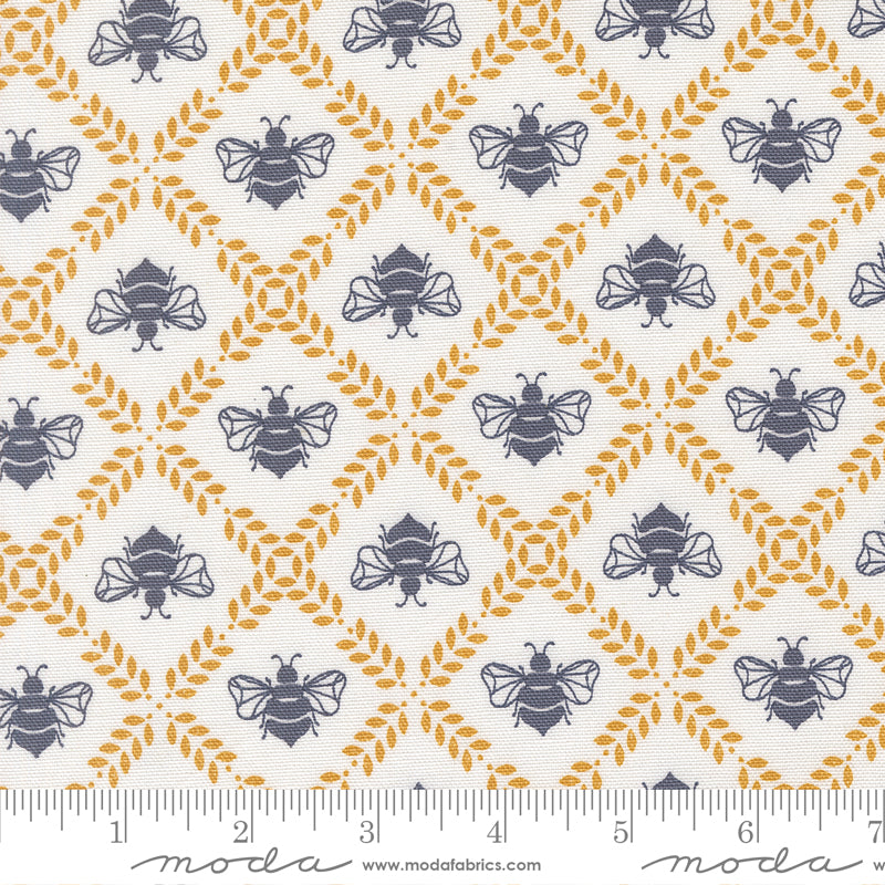 Cream cotton canvas fabric with navy bees and golden vine diamond motifs from the Sun Drenched collection by Sweetfire Road for Moda.