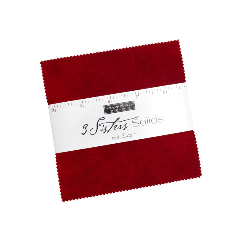 3 Sisters Solids Charm Pack by Moda Fabrics containing 42 assorted 5-inch solid fabric squares.