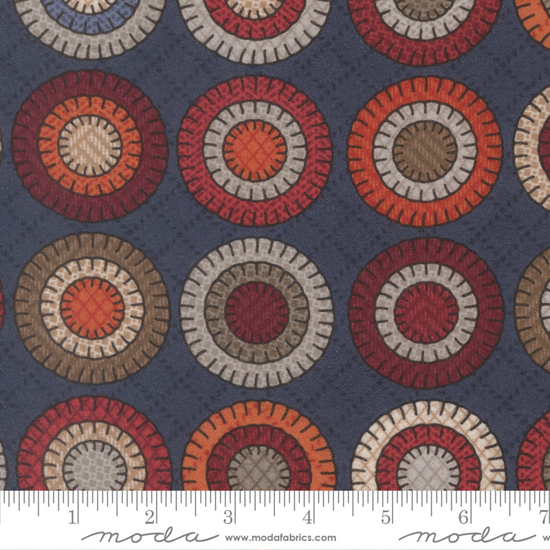 Penny Cheater Indigo flannel fabric by Primitive Gatherings for Moda Fabrics showing circular penny motifs on blue background.