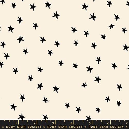 Starry Natural cotton fabric by Ruby Star Society featuring scattered black stars on a soft cream background.