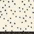 Starry Natural cotton fabric by Ruby Star Society featuring scattered black stars on a soft cream background.