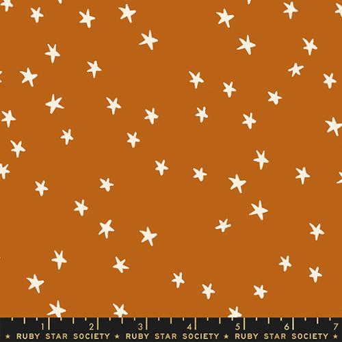 Starry Saddle cotton fabric by Ruby Star Society featuring scattered cream stars on a warm saddle brown background.
