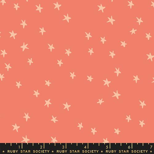 Starry Papaya cotton fabric by Ruby Star Society featuring scattered cream stars on a soft papaya-peach background.