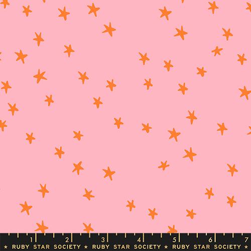 Starry New Rosebud fabric by Alexia Abegg for Ruby Star Society featuring scattered orange star motifs on a soft rose pink background.