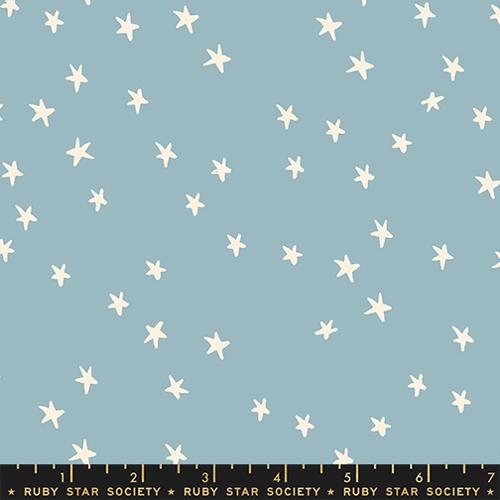 Starry New Soft Blue fabric by Alexia Abegg for Ruby Star Society featuring scattered cream-white stars on a light blue background.
