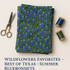 olded fabric stack showing the bluebonnet print clearly with scissors and thread spools.
