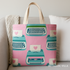 A bright sewing room scene featuring a tote bag and decorative pillow made from Ruby Star Society’s Best Day Ever Typewriters Posy fabric by Melody Miller for Moda Fabrics, showing teal and pink retro typewriters with heart details on a rosy pink background. The image includes the “My Fabric Villa” watermark in the bottom-right corner.