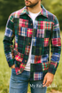 A man wearing a stylish jacket made from multicolor Nantucket patchwork madras plaid fabric in shades of green, red, navy, and yellow, photographed outdoors in natural light with the “My Fabric Villa” watermark on the bottom right.
