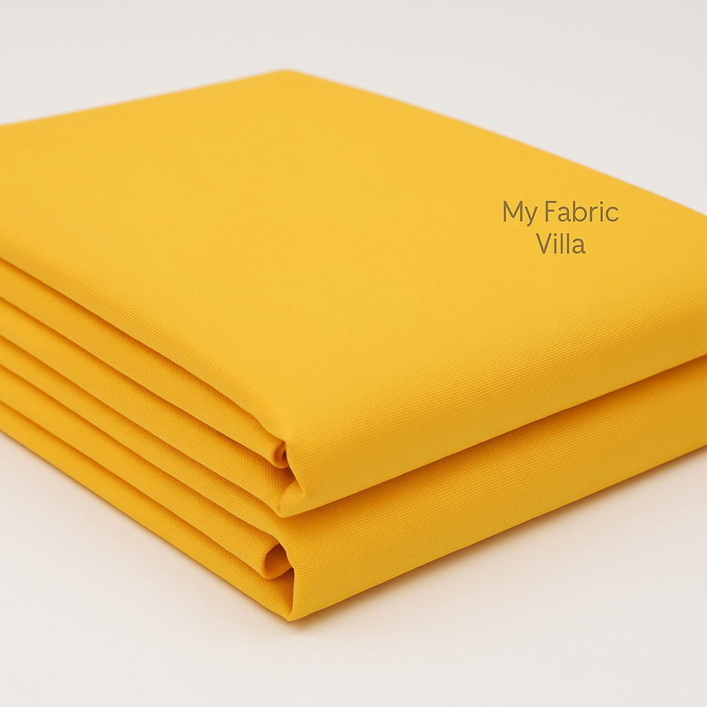 Folded stack of Bella Solids Yellow Fabric by Moda Fabrics showing soft, colorfast cotton suitable for quilting and sewing.