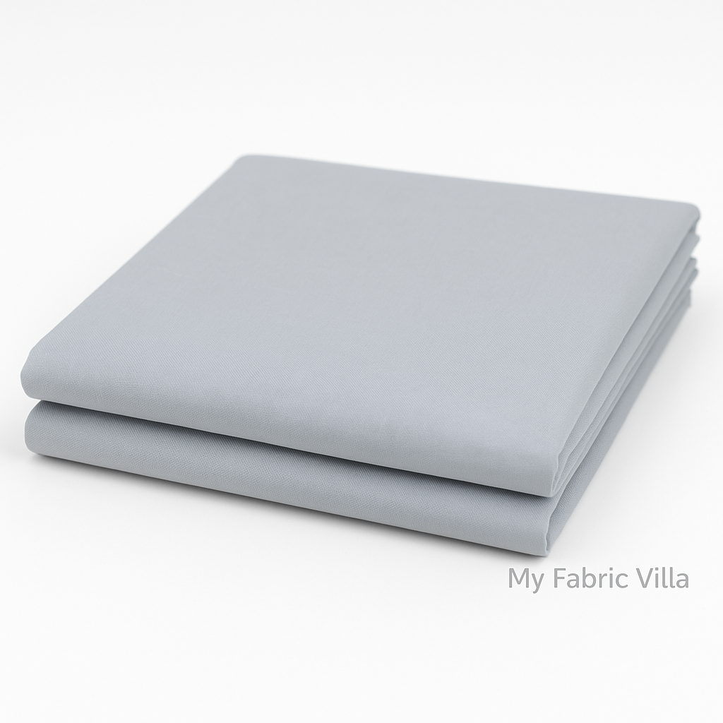 Folded stack of Bella Solids Silver Fabric by Moda Fabrics showing colorfast cotton suitable for quilting and sewing.