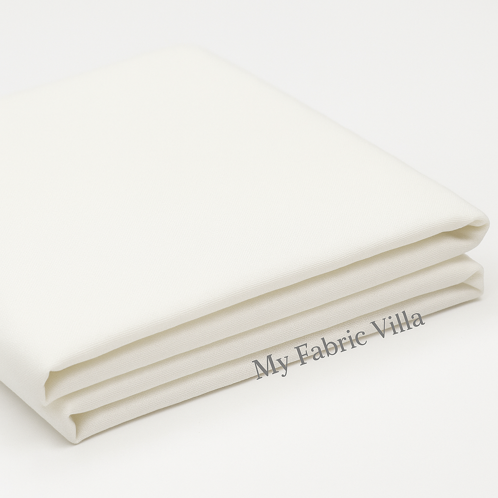 Folded stack of Bella Solids Off White Fabric by Moda Fabrics showing smooth, colorfast cotton suitable for quilting and sewing.
