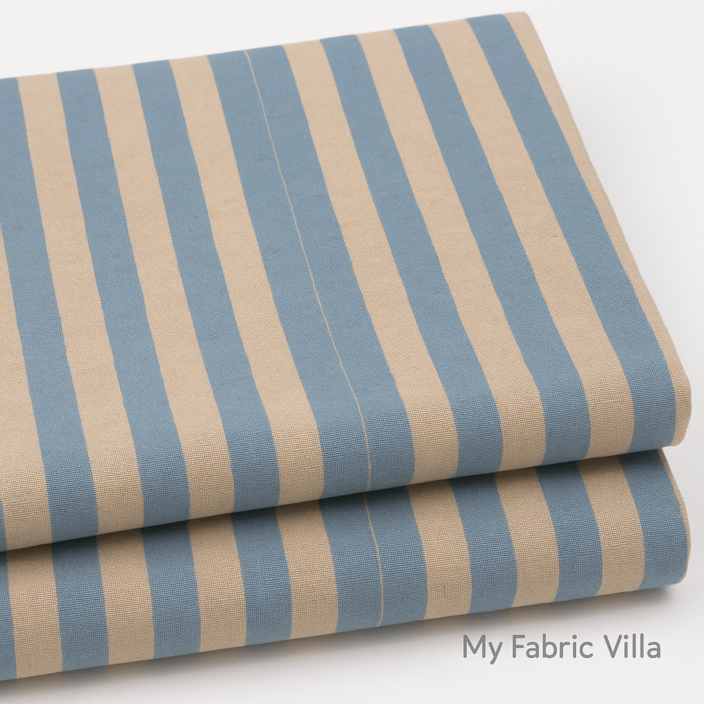 Folded stack of Primavera Cabana Stripe Periwinkle Canvas Fabric by Rifle Paper Co. for Cotton + Steel showing textured blue and beige stripes.