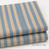 Folded stack of Primavera Cabana Stripe Periwinkle Canvas Fabric by Rifle Paper Co. for Cotton + Steel showing textured blue and beige stripes.