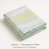 Neatly folded Atrium Hexapoint Mint Fabric by Joel Dewberry for Free Spirit Fabrics showing soft mint, gray, and yellow geometric hexagon design.
