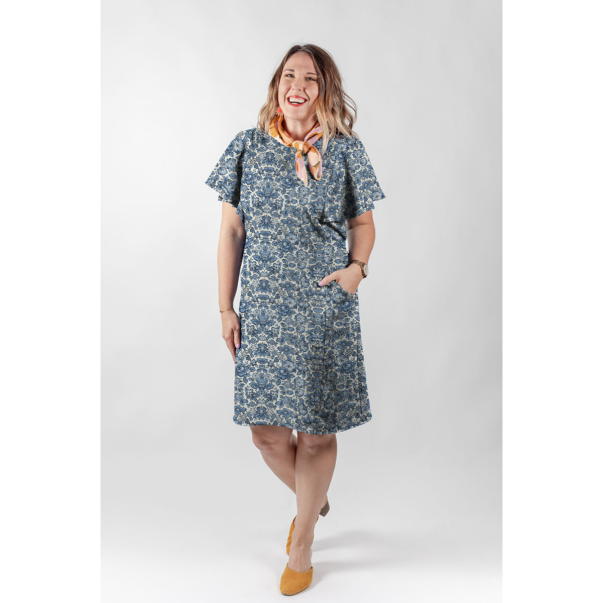 Woman wearing a handmade shift dress sewn from Tim Holtz Palette Indigo Wallpaper cotton canvas, showcasing the elegant vintage indigo floral pattern for apparel sewing projects.