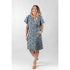 Woman wearing a handmade shift dress sewn from Tim Holtz Palette Indigo Wallpaper cotton canvas, showcasing the elegant vintage indigo floral pattern for apparel sewing projects.