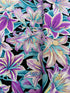 Kaffe Fassett Amaryllis Lavender polyester quilting cotton – lavender and teal amaryllis flowers on a black background, 44″ wide