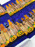 Feline Spooky Cats on Fence cotton fabric by Timeless Treasures featuring colorful Halloween cats, pumpkins, spider webs, and a rustic wooden fence.