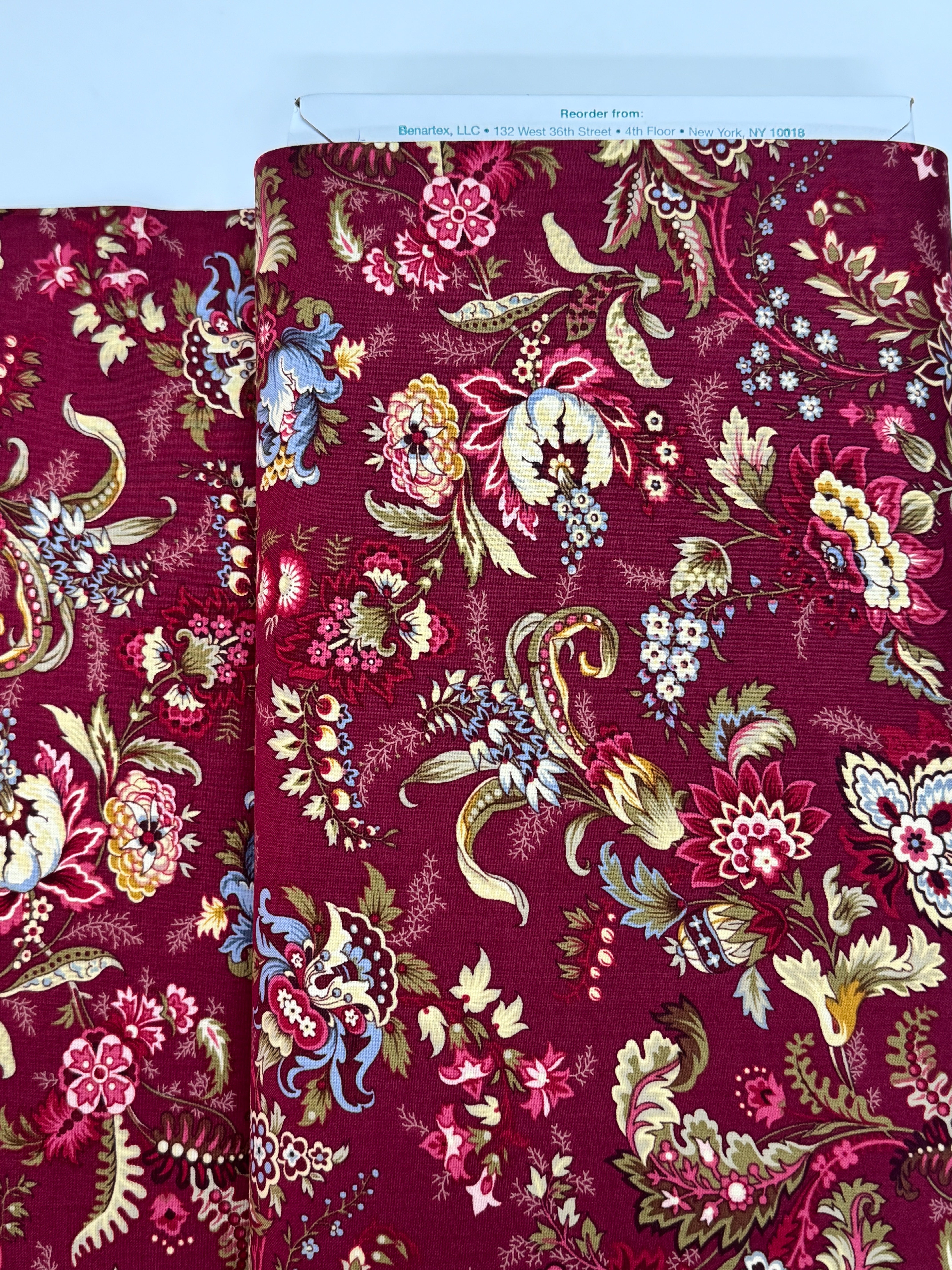 Marseille Red floral cotton fabric by Dover Hill for Benartex featuring ornate botanical flowers and foliage in burgundy, gold, cream, olive green, and blue on a rich red background.