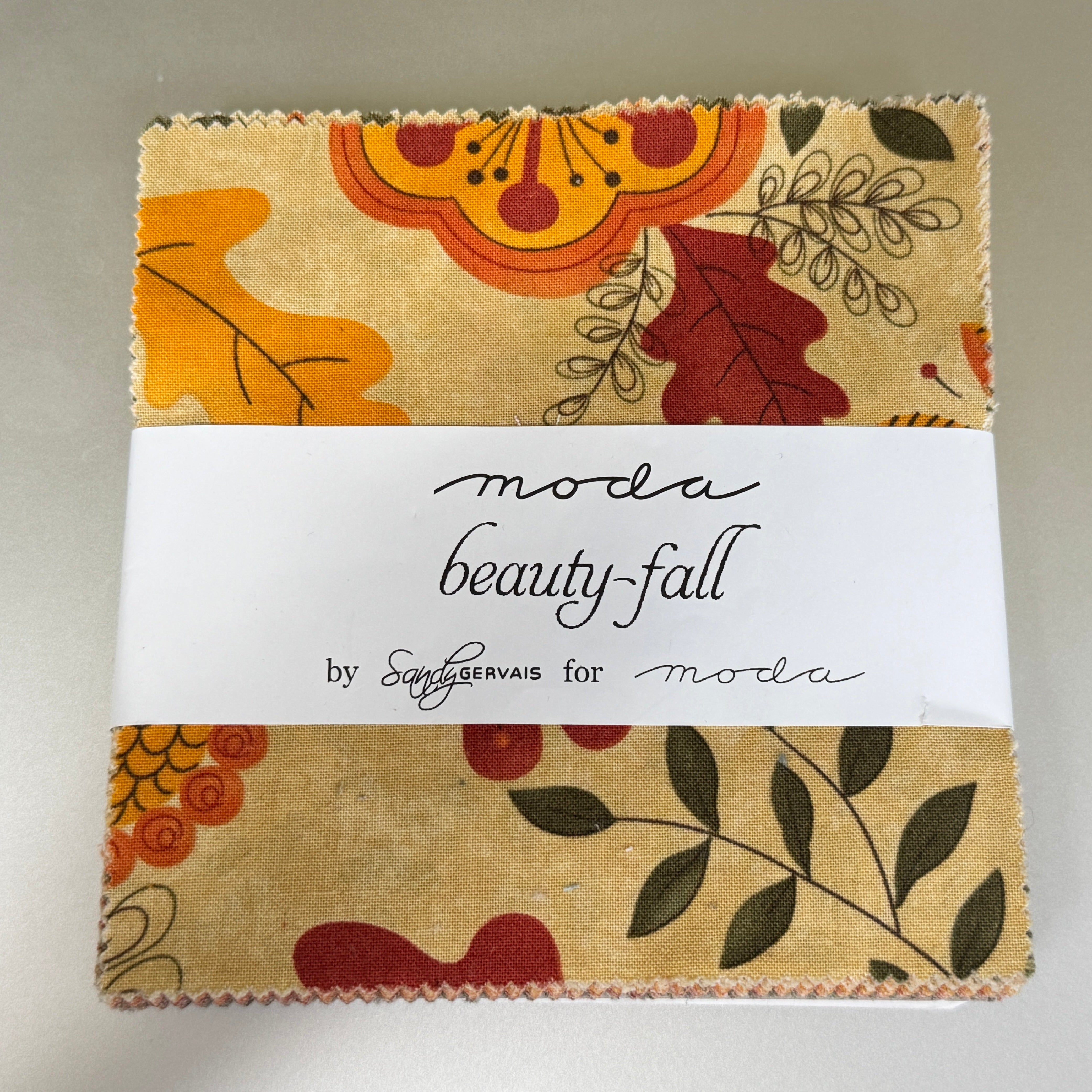 Beauty-Fall Charm Pack by Sandy Gervais for Moda Fabrics featuring 42 coordinated 5-inch cotton fabric squares with autumn florals, leaves, berries, and seasonal prints in warm fall colors.