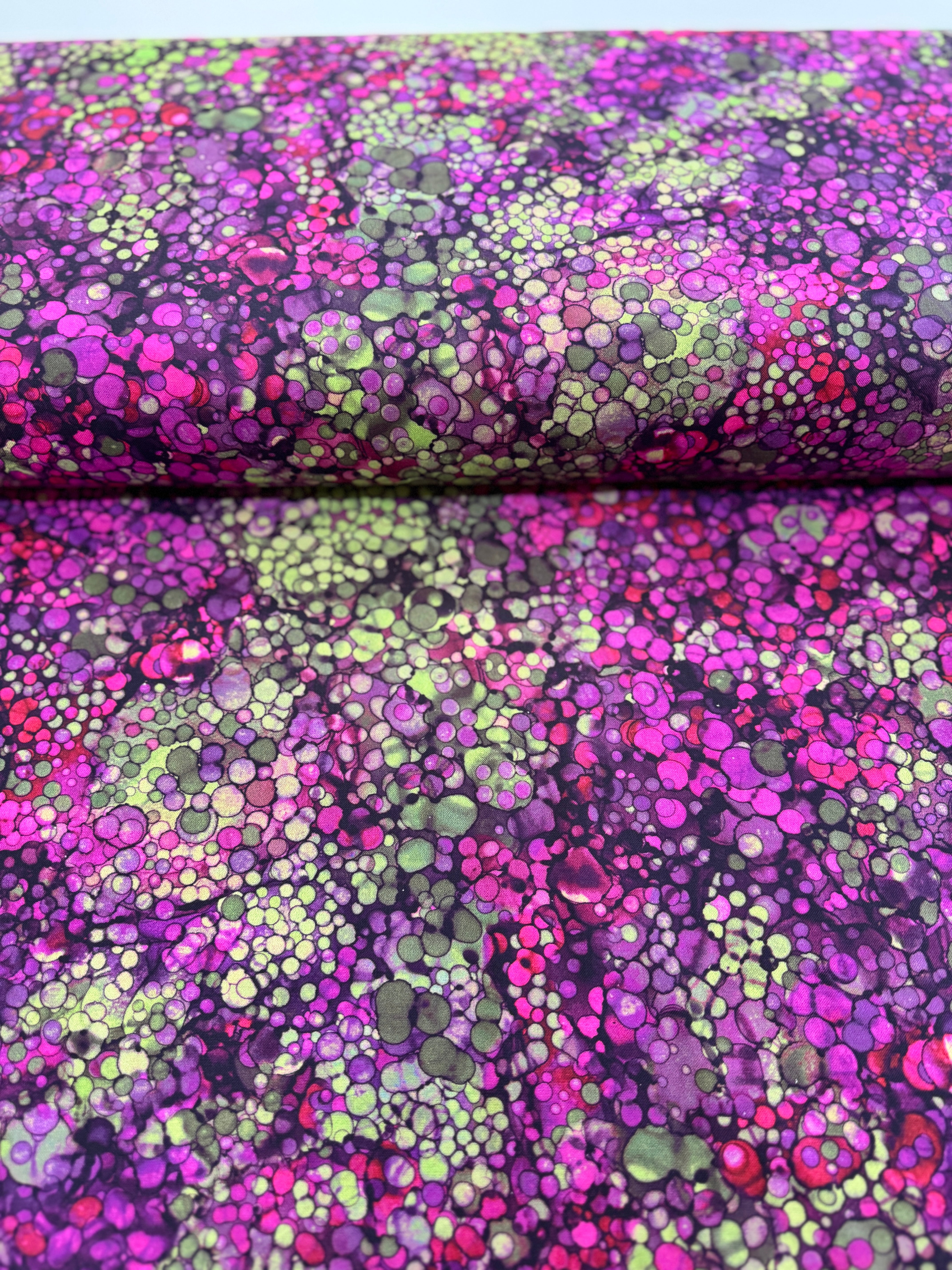 Bliss Wide Backing – Heather 108" wide quilt backing fabric by Northcott, featuring a digitally printed mottled green and purple background with subtle scattered spots.