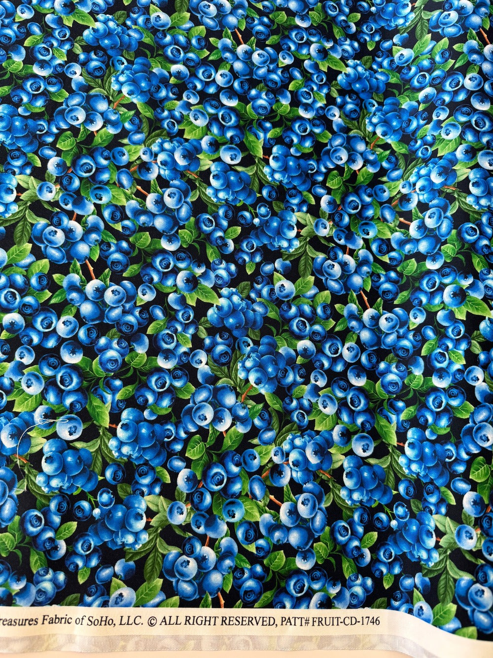 Blueberry Delight - Blueberries Bush Fabric by Timeless Treasures featuring realistic blueberries with green leaves on a navy background.