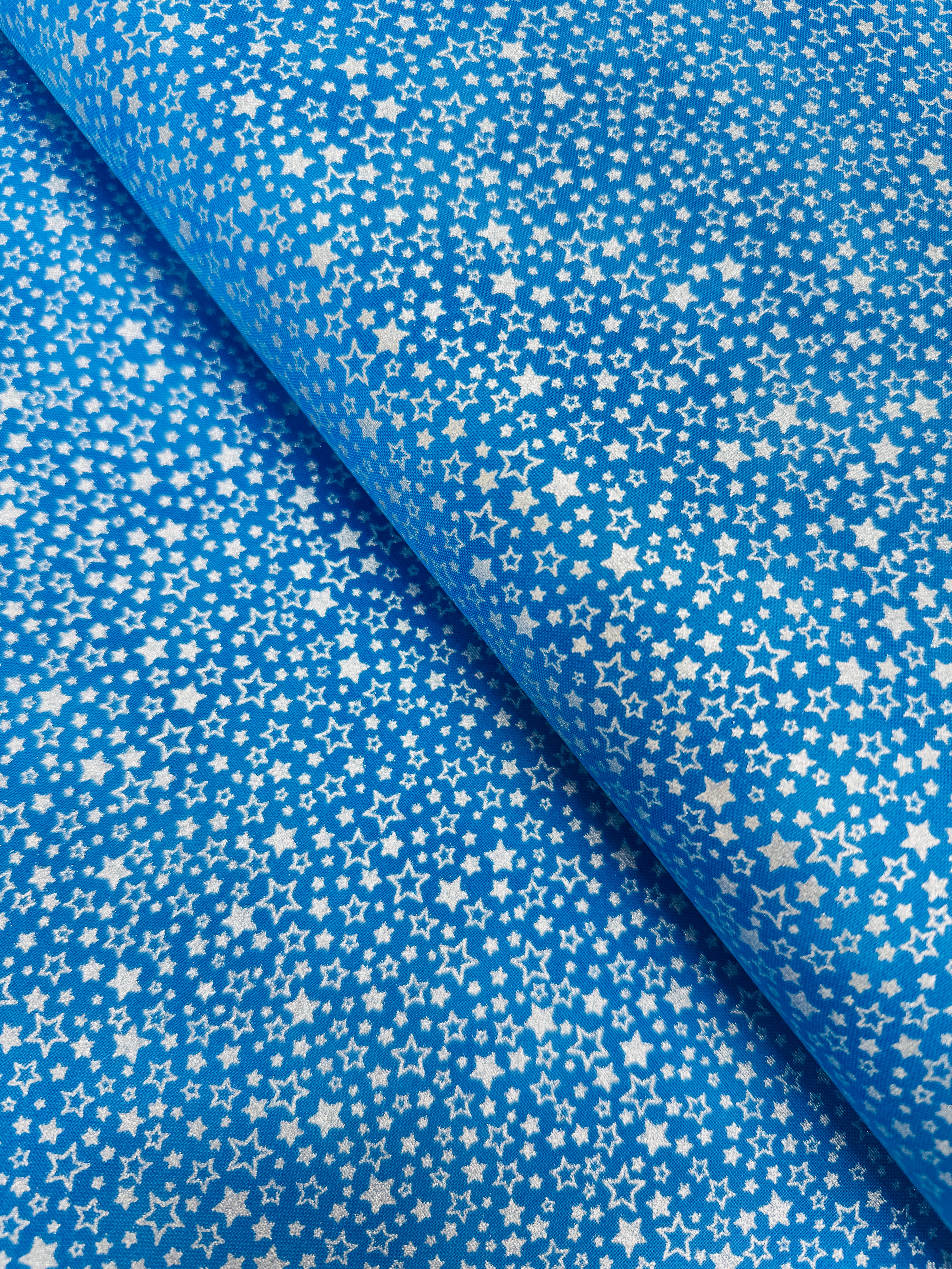 Holiday Charms fabric with silver stars on blue by Studio RK for Robert Kaufman.