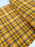 Close-up of Loomcraft Plaid Mustard fabric by Robert Kaufman – 100% cotton, heavyweight woven plaid in warm yellow tones, ideal for quilting or crafts.
