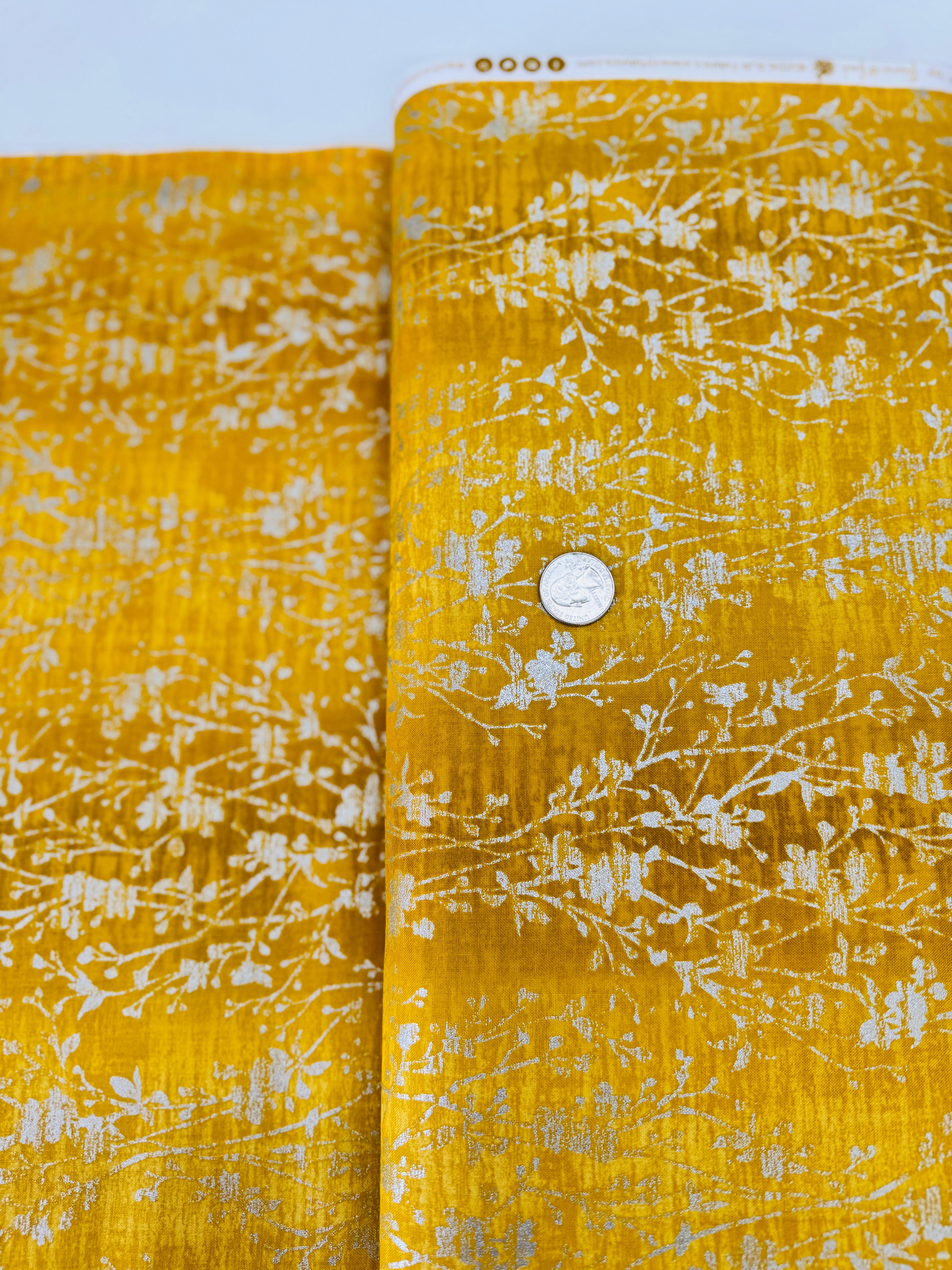 Shiny Objects – Velvety Vines Daffodil Metallic Fabric by Flaurie & Finch – Yellow cotton fabric with delicate gold metallic vine pattern.