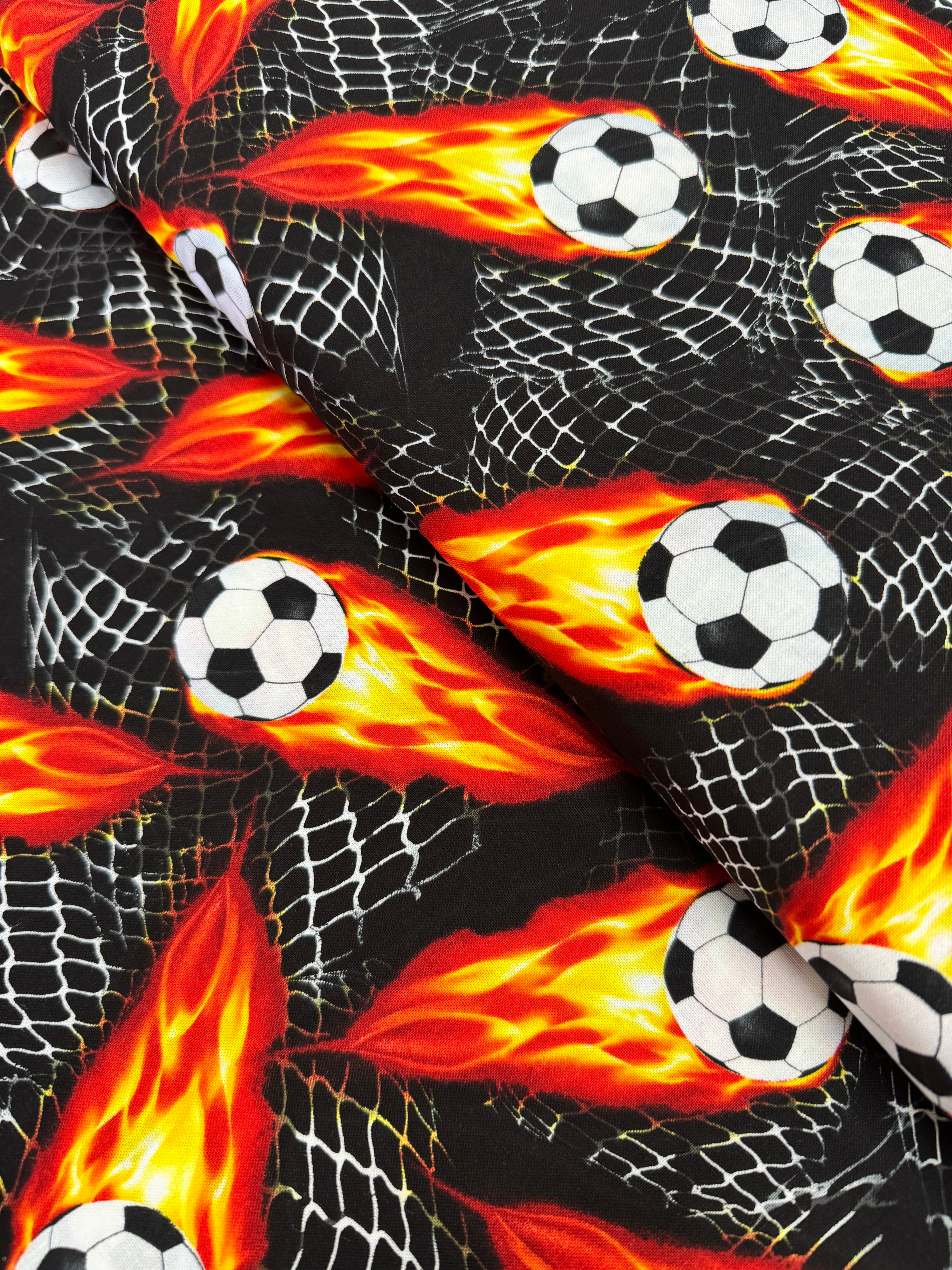 Flaming Soccer Balls Fabric – Goal! by Gail Cadden for Timeless Treasures, black cotton fabric with fiery soccer balls.